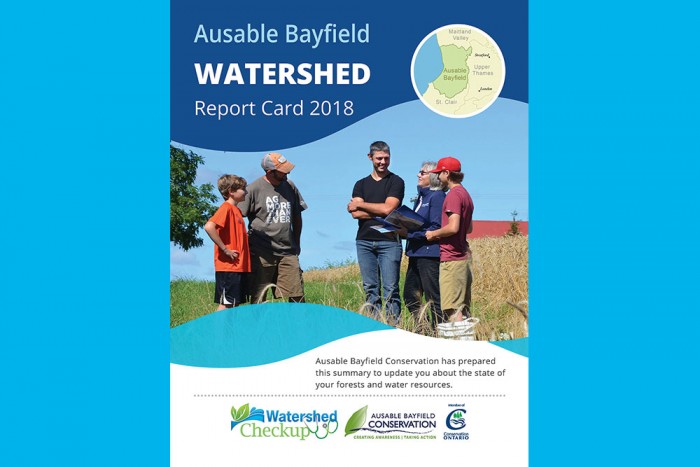 A photo of with staff and landowners at field on cover of 2018-2022 Watershed Report Card.