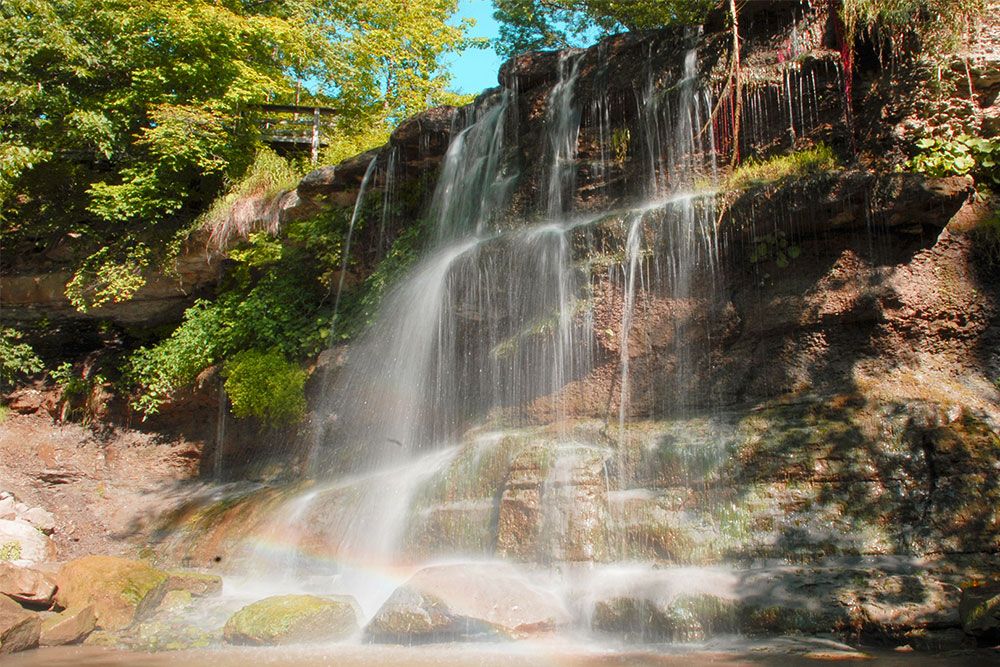 A photo of Rock Glen Falls, and rainbow effect, at Rock Glen Conservation Area.