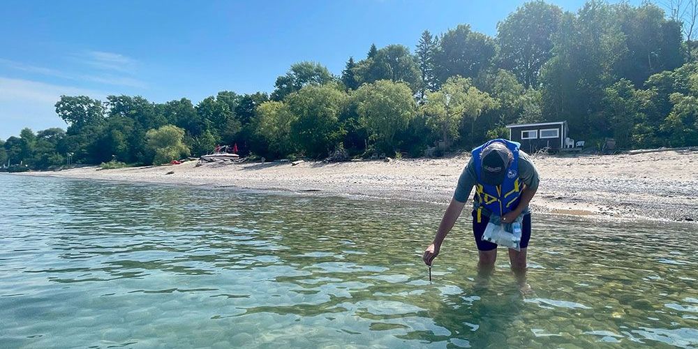 A photo of ABCA staff taking water sample in Lake Huron.