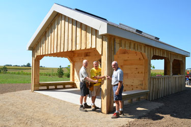 Volunteers put the 'Last Spike' or last nail into the construction of the new Woodland Reflection Shelter pavilion along the South Huron Trail.